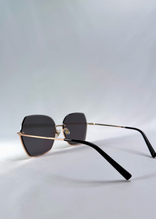 Side view of Aureon sunglasses in Silver Smoke, featuring rimless metal frame, silver temples, and grey lenses, showing the lens shape and temple profile. 