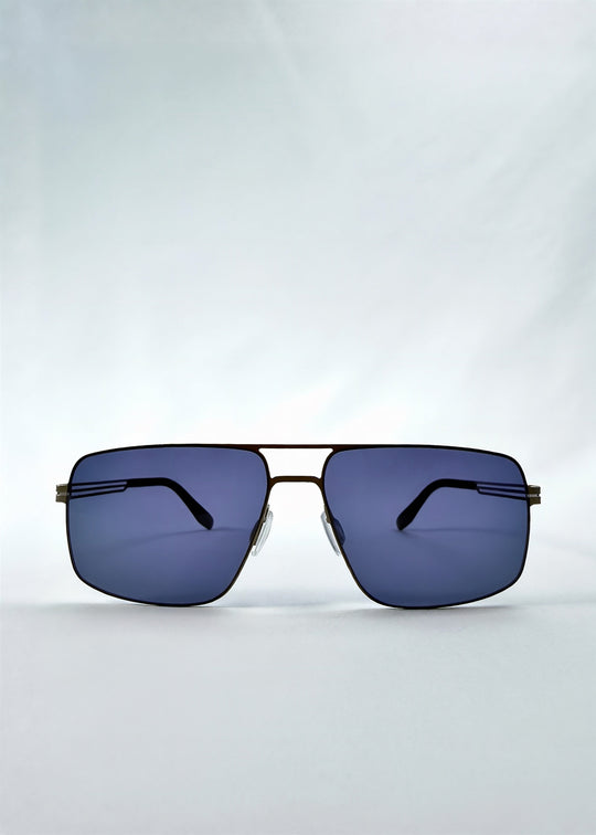 Front view of Axiom sunglasses in Blue Graphite, featuring blue-graphite rectangular metal frame and blue tinted polarized lenses, showing the full front silhouette. 