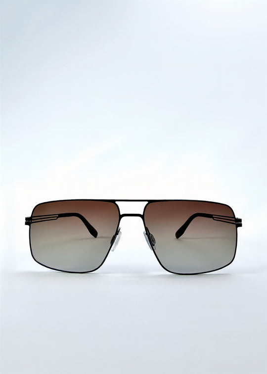Front view of Axiom sunglasses in Eclipse Black, featuring dark rectangular metal frame and shadowed gradient polarized lenses, showing the full front silhouette.