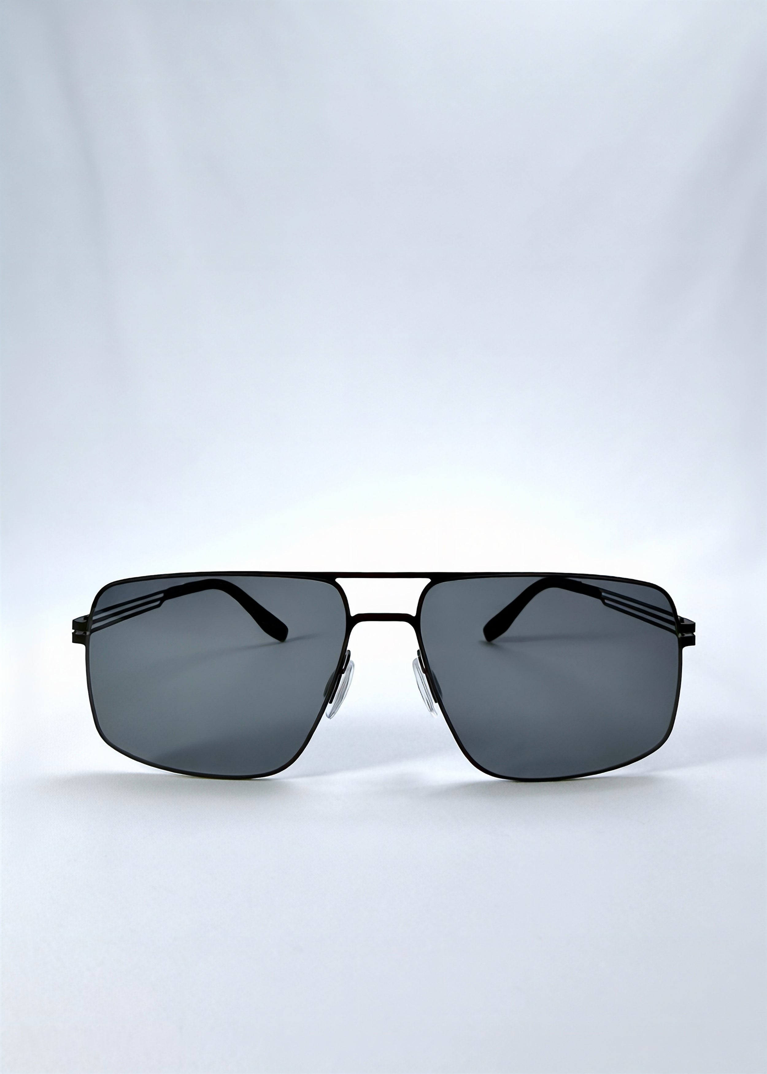 Front view of Axiom sunglasses in Matte Black, featuring matte black rectangular metal frame and grey polarized lenses, showing the full front silhouette.