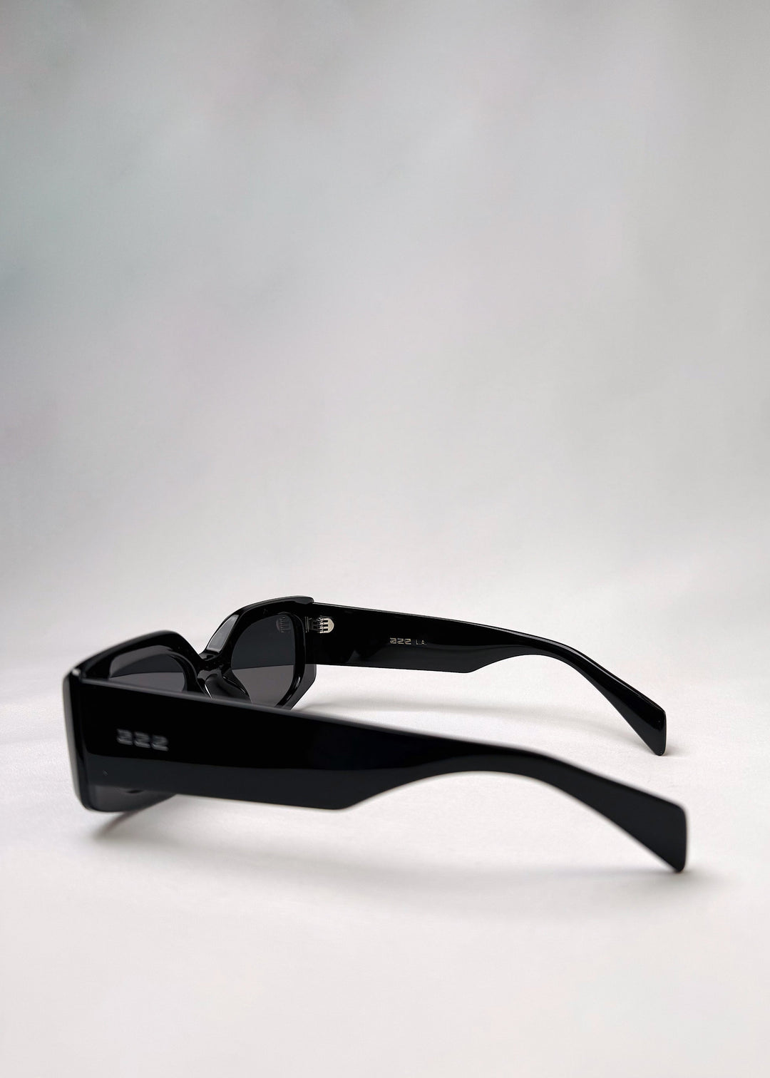 Side view of Bellatrix black acetate sunglasses showcasing the bold frame and smooth design. 
