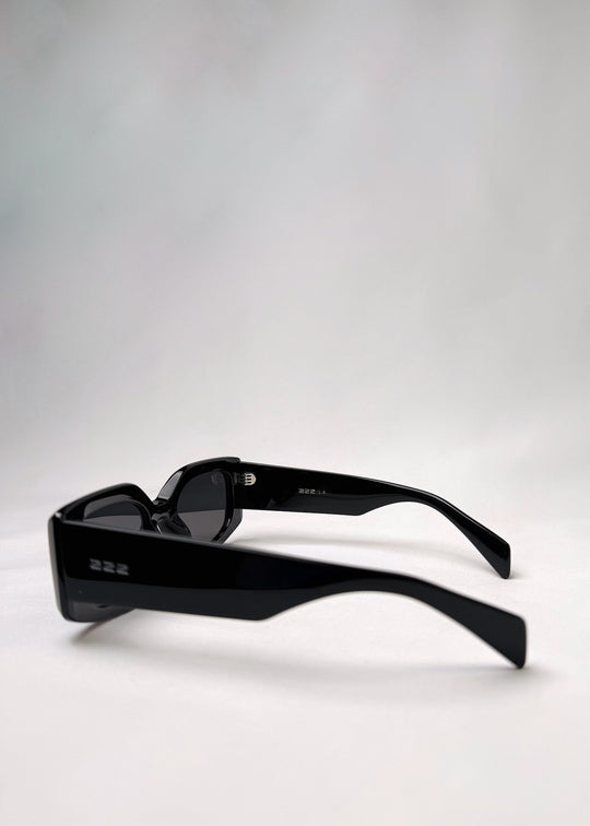 Side view of Bellatrix black acetate sunglasses showcasing the bold frame and smooth design. 