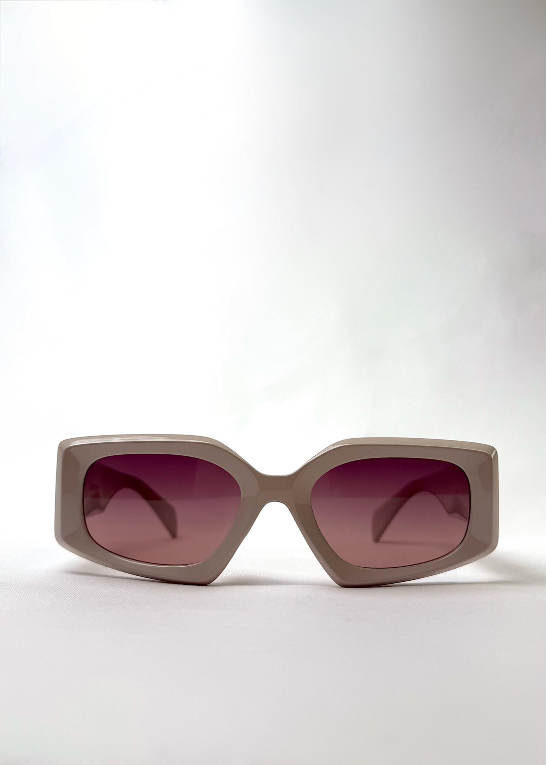 Front view of Bellatrix warm taupe acetate sunglasses featuring an oversized frame and UV400 polarized lenses. 