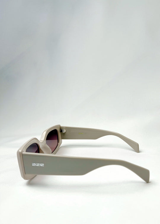 Side view of Bellatrix warm taupe sunglasses showcasing thick acetate temples and sleek, modern design. 