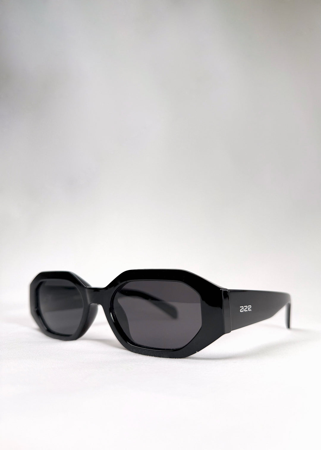Angled view of Castor sunglasses in Black, highlighting the geometric silhouette and glossy acetate finish. 