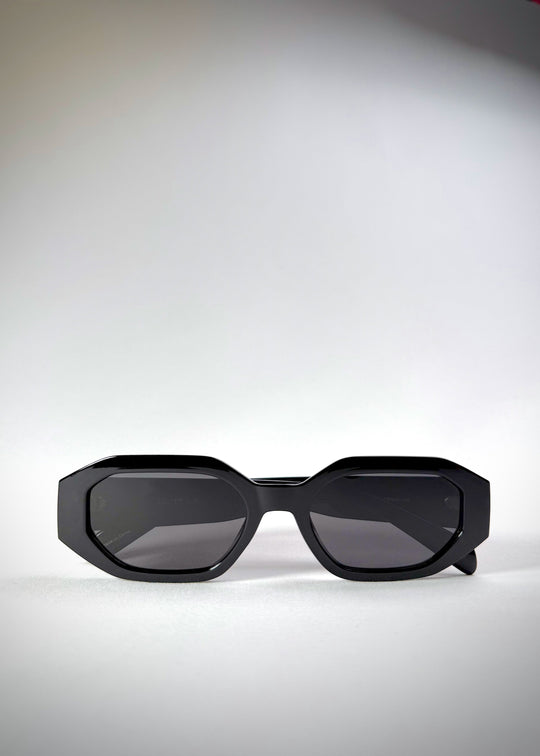 Folded Castor - Black acetate sunglasses, emphasizing its compact, travel-friendly design. 