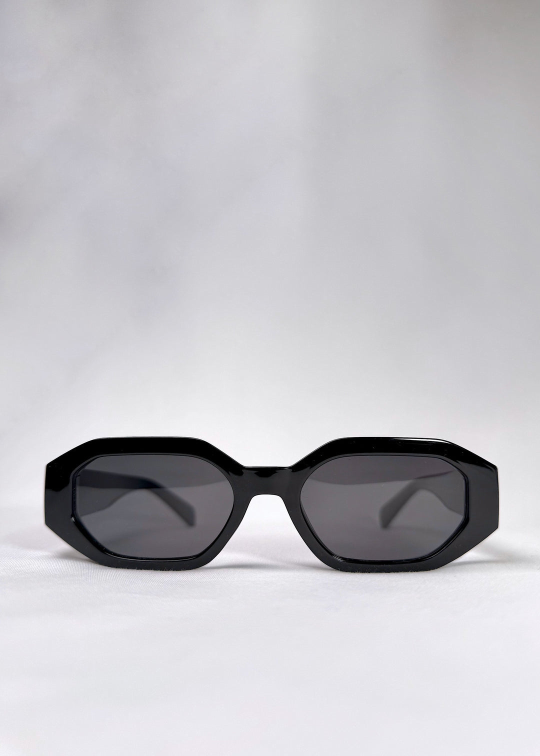 Front view of Castor - Black acetate prescription sunglasses, featuring a bold hexagonal frame and glossy black finish. 