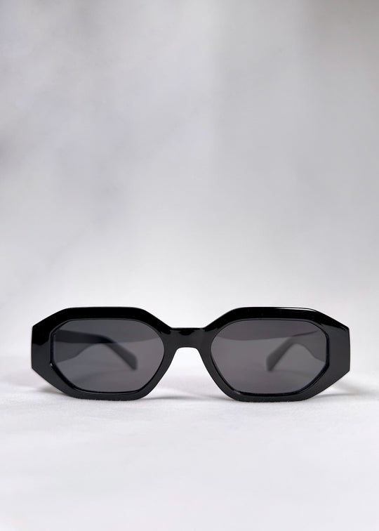 Front view of Castor - Black acetate prescription sunglasses, featuring a bold hexagonal frame and glossy black finish. 