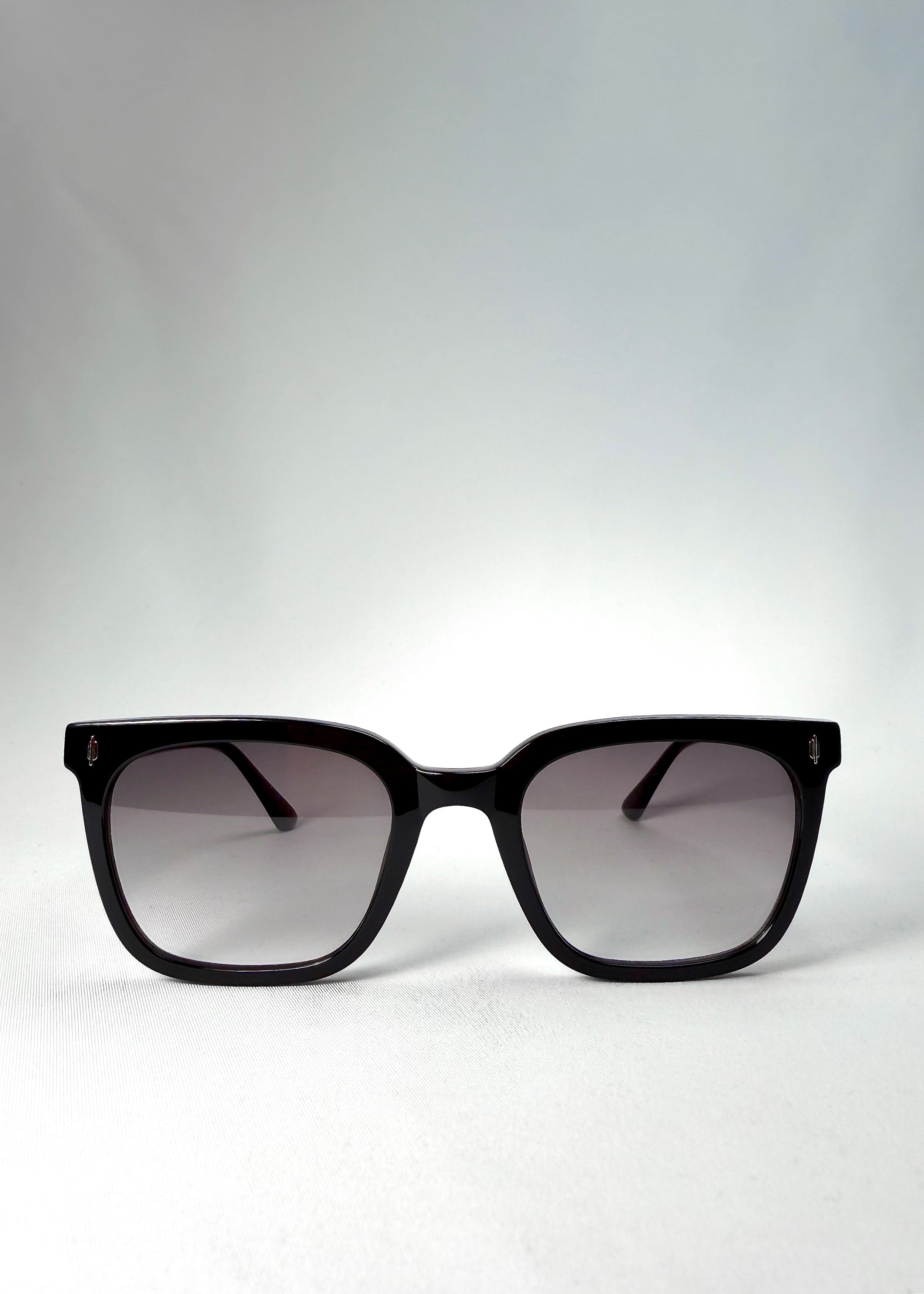 Front view of Cavalin sunglasses in Graphite Haze with glossy black acetate frame and gradient smoke lenses.