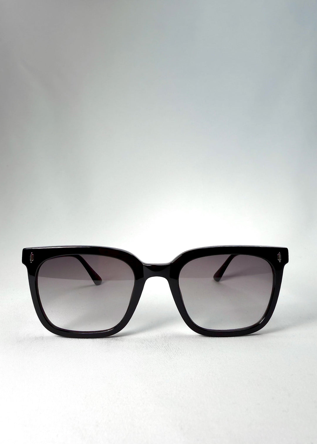 Front view of Cavalin sunglasses in Graphite Haze with glossy black acetate frame and gradient smoke lenses. 