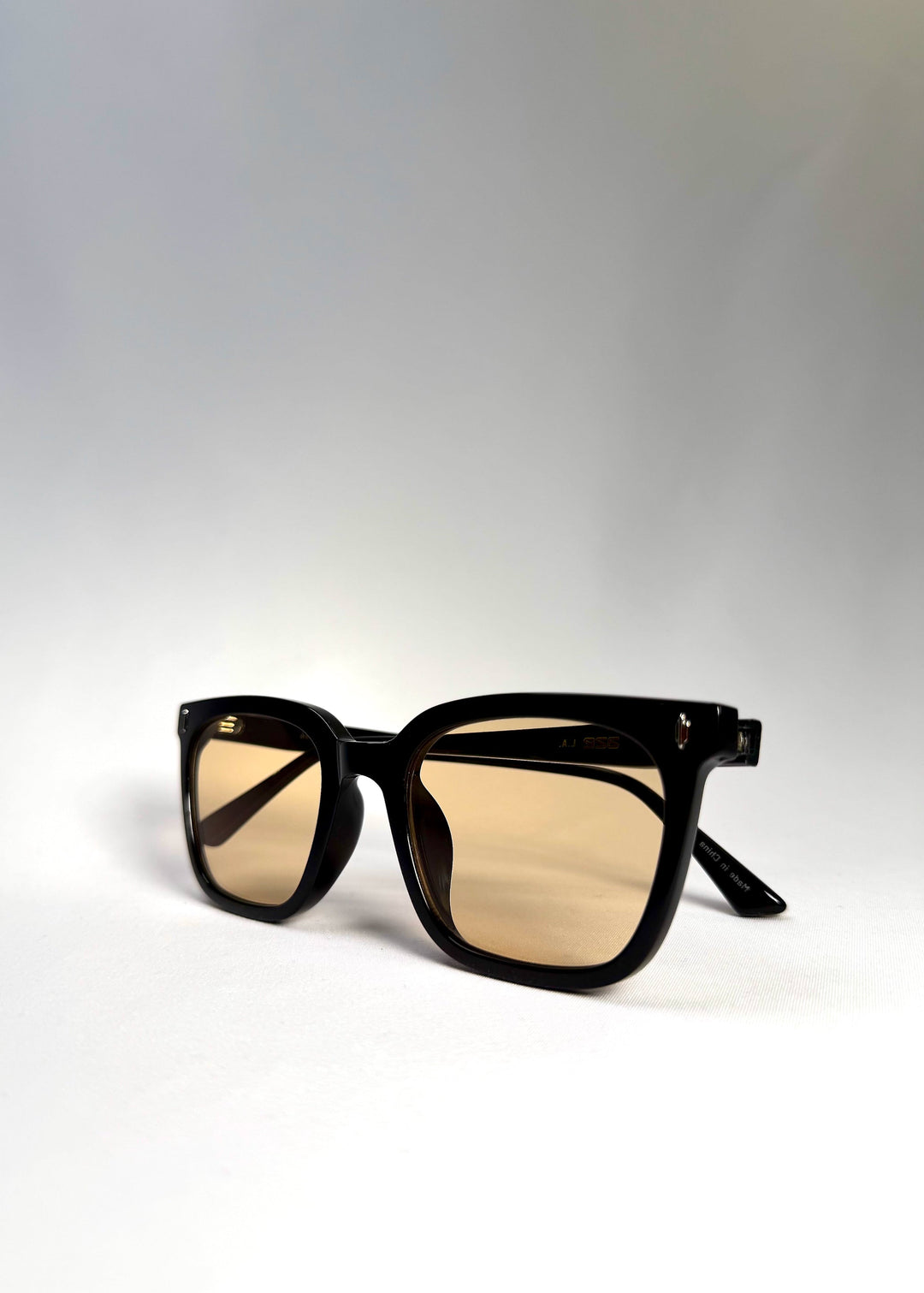 Close-up angled view of Cavalin Pitchline showing matte frame finish and warm-tint lenses. 