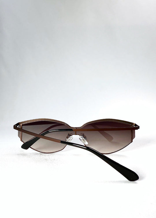Back view of Celestia – Ash Fade sunglasses in a folded position, displaying the slim temples and nose pads. 