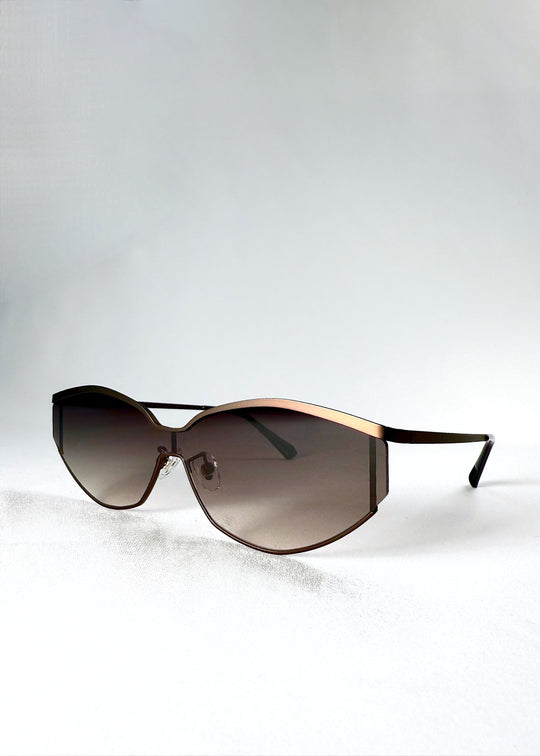 Angled front view of Celestia – Ash Fade sunglasses showing the soft gradient lenses and curved frame. 