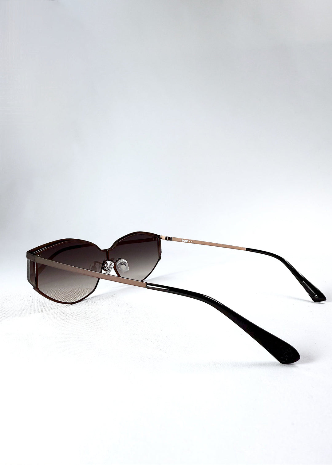 Side angle view of Celestia – Ash Fade sunglasses highlighting the contour of the frame and lens edge. 