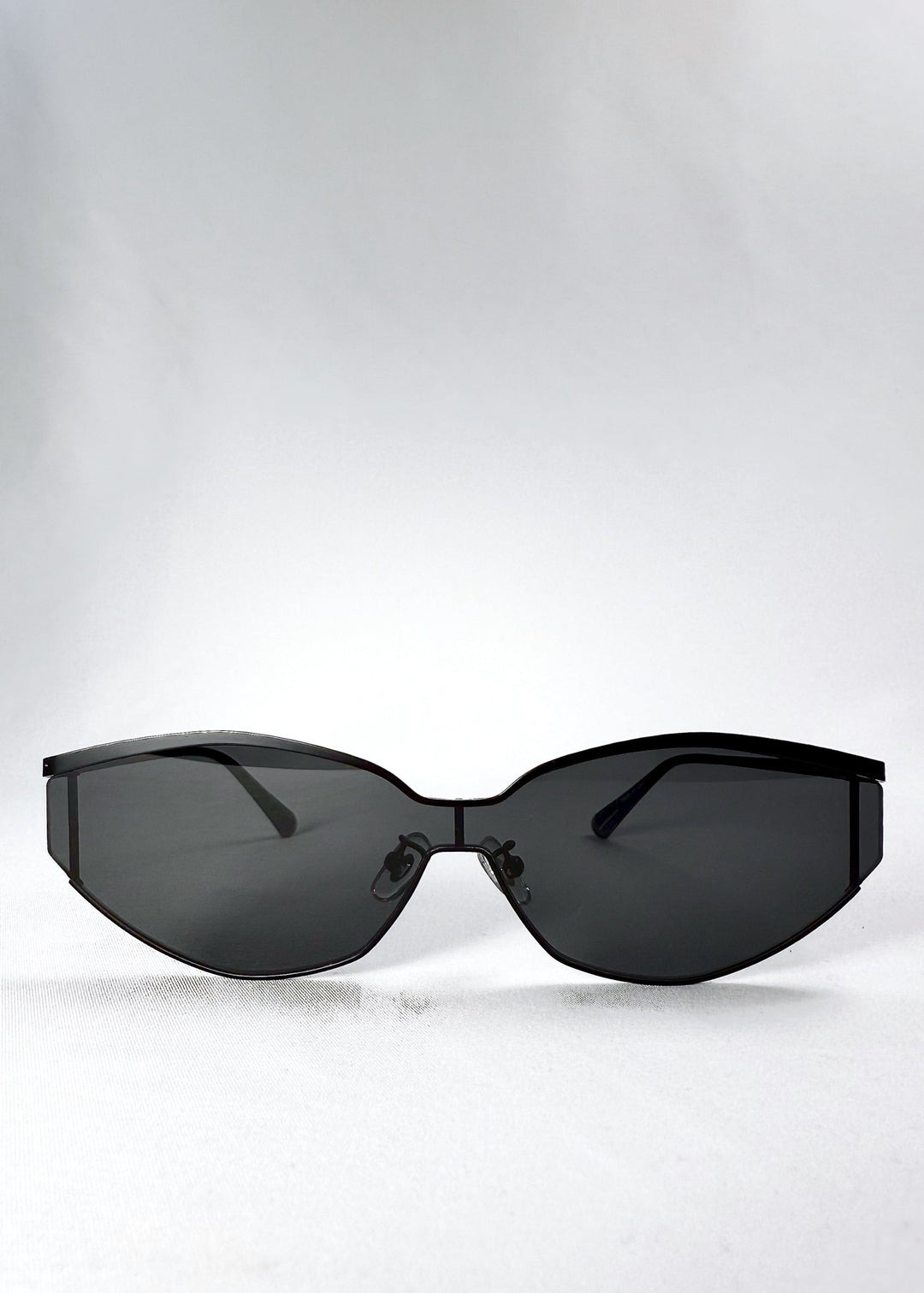 Front view of Celestia – Matte Black showing the semi-rimless black metal frame and angular dark smoke lenses. 