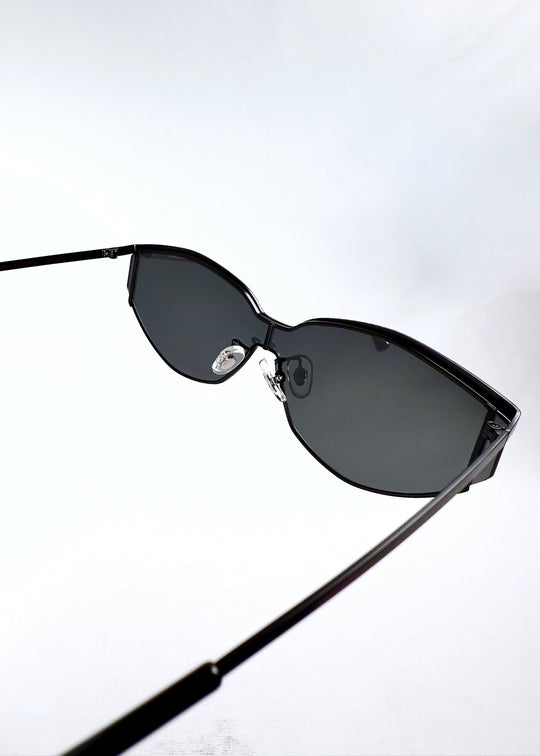 Inside view of Celestia – Matte Black sunglasses revealing the matte black inner arms and nose pad placement. 