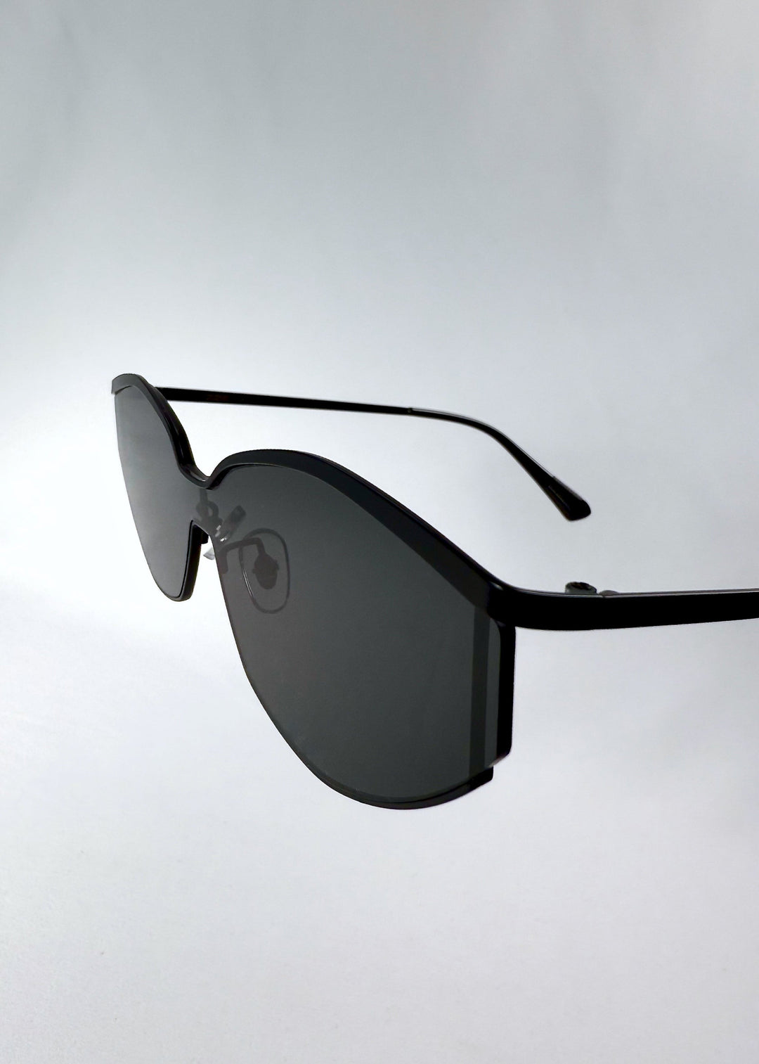 Close-up of Celestia – Matte Black’s HD nylon lenses, emphasizing the smoky tint and edge finishing. 