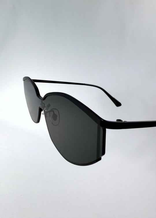 Close-up of Celestia – Matte Black’s HD nylon lenses, emphasizing the smoky tint and edge finishing. 