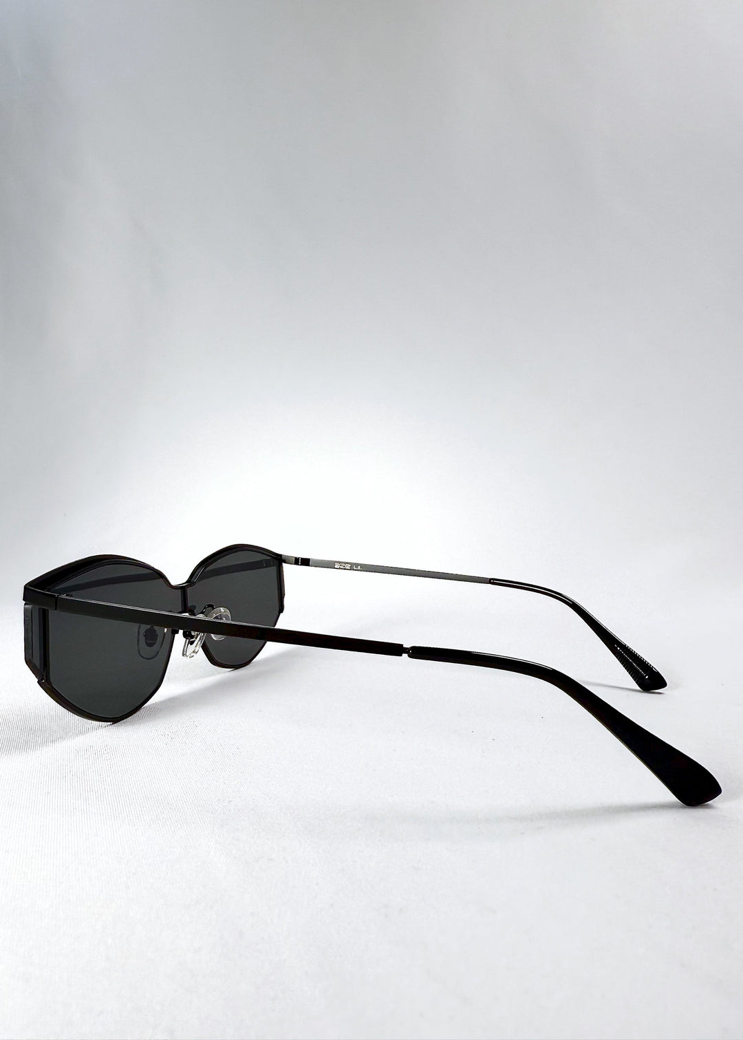 Side view of Celestia – Matte Black sunglasses highlighting the ultra-thin metal temples and ergonomic curve. 