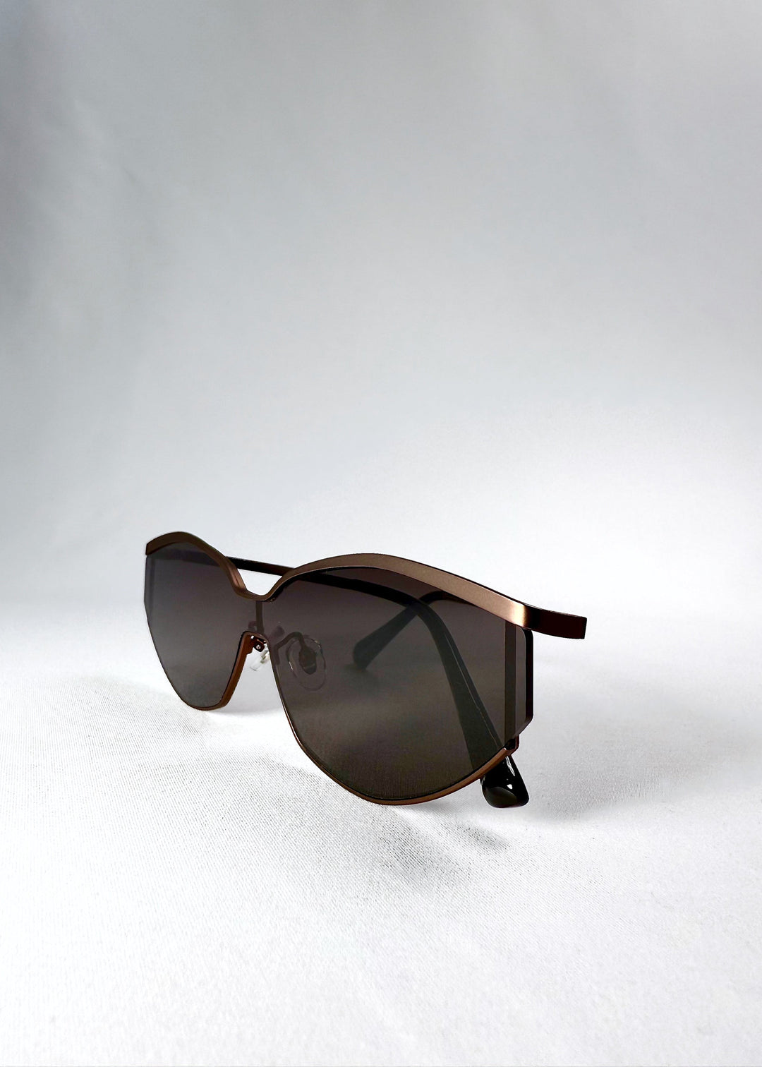 Side view of Celestia – Mocha Bronze in a folded position, displaying temple design and matte bronze tone. 