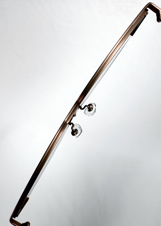 Close-up of the adjustable nose pads on Celestia – Mocha Bronze, showing the clear pads and the bronze metal browline bar. 