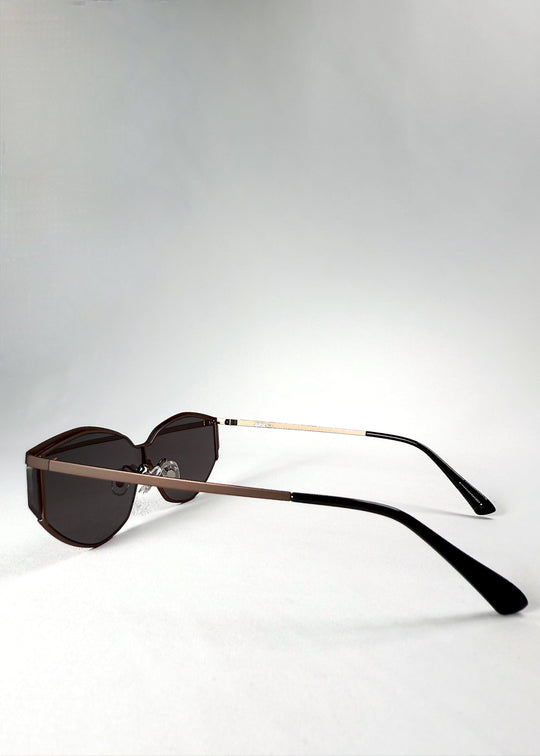 Angled view of the Celestia – Mocha Bronze sunglasses from the side, highlighting the slim temple arms and two-tone bronze-and-black finish. 