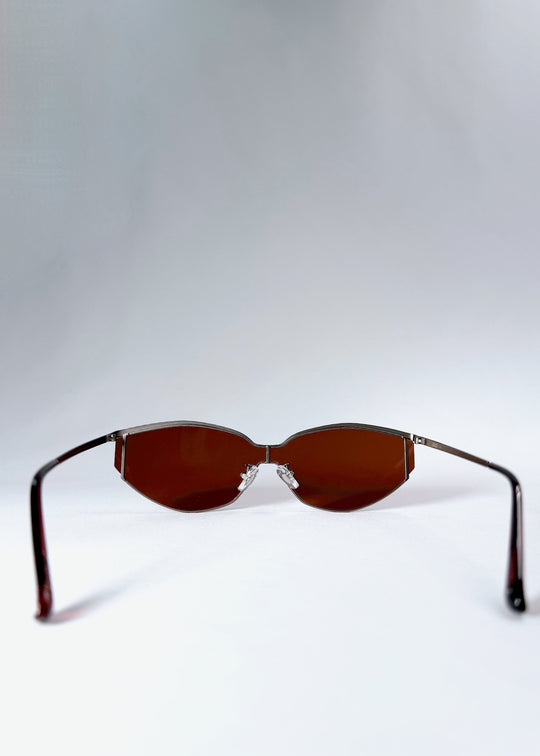 Back view of Celestia – Ruby Smoke sunglasses featuring adjustable nose pads and curved ear tips for comfort. 