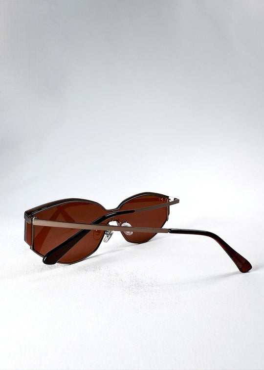 Side view of Celestia – Ruby Smoke sunglasses in folded position, showing the temple curvature and hinge connection. 