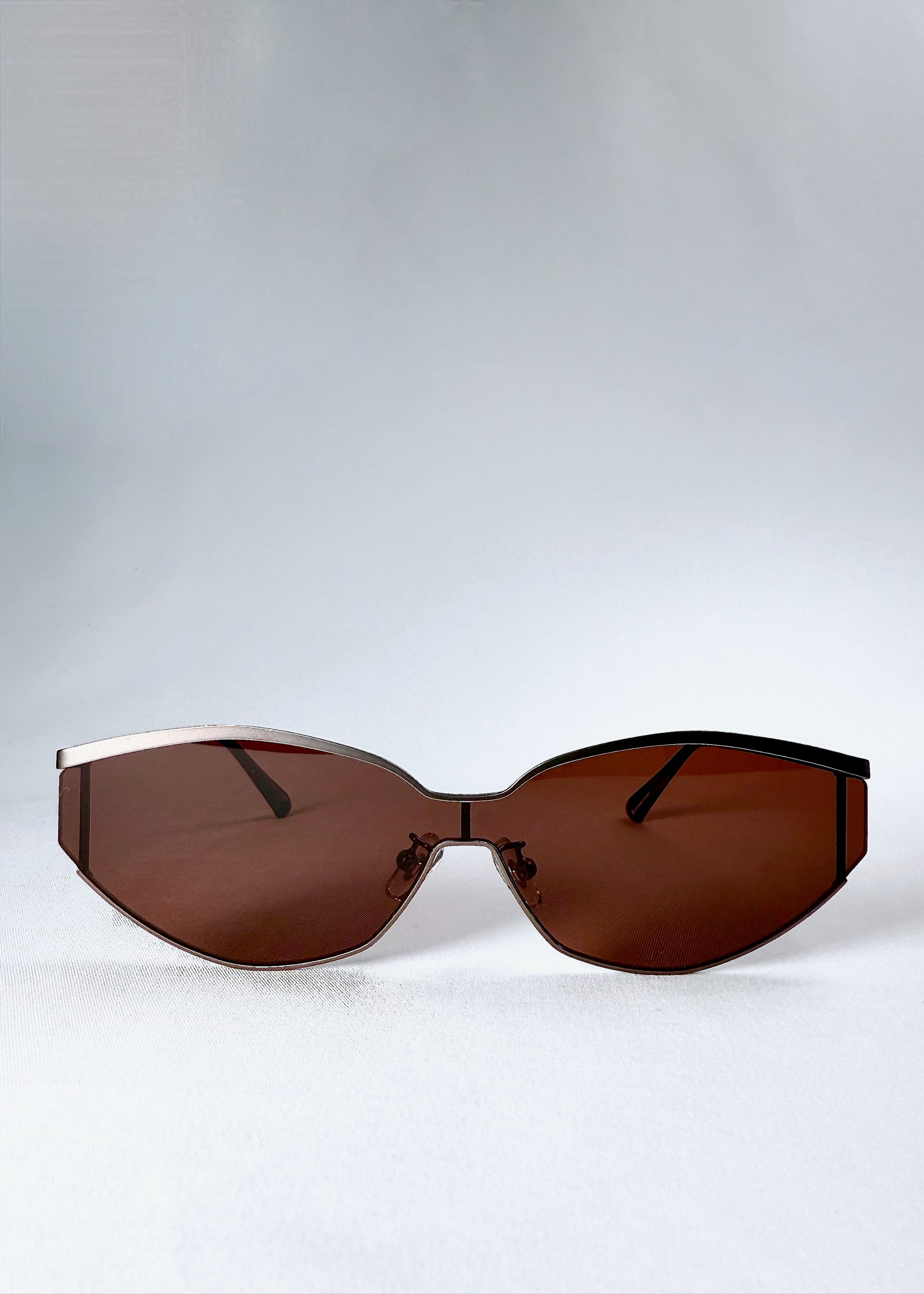 Front view of Celestia – Ruby Smoke sunglasses showcasing the semi-rimless design and warm-toned HD nylon lenses.