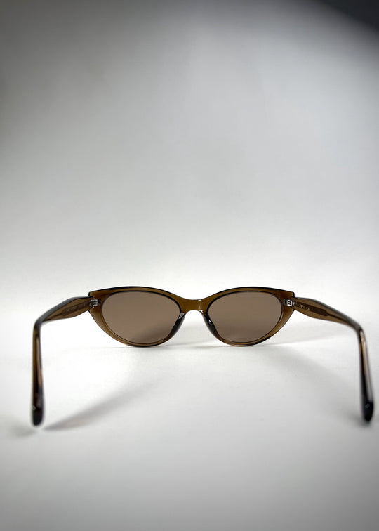 Back view of Chara sunglasses in Champagne Brown, featuring a translucent champagne brown cat-eye acetate frame and UV400 lenses, showing the inside frame and open temples. 