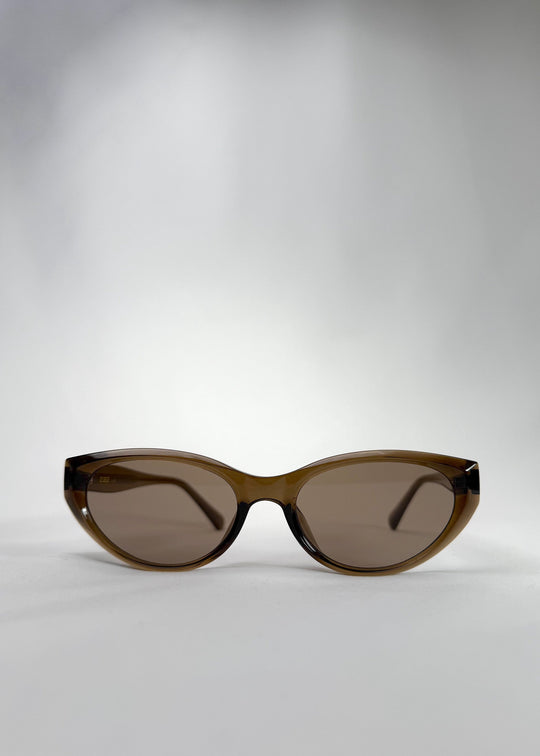 Front view of Chara sunglasses in Champagne Brown, featuring a translucent champagne brown cat-eye acetate frame and UV400 lenses, showing the full front silhouette. 