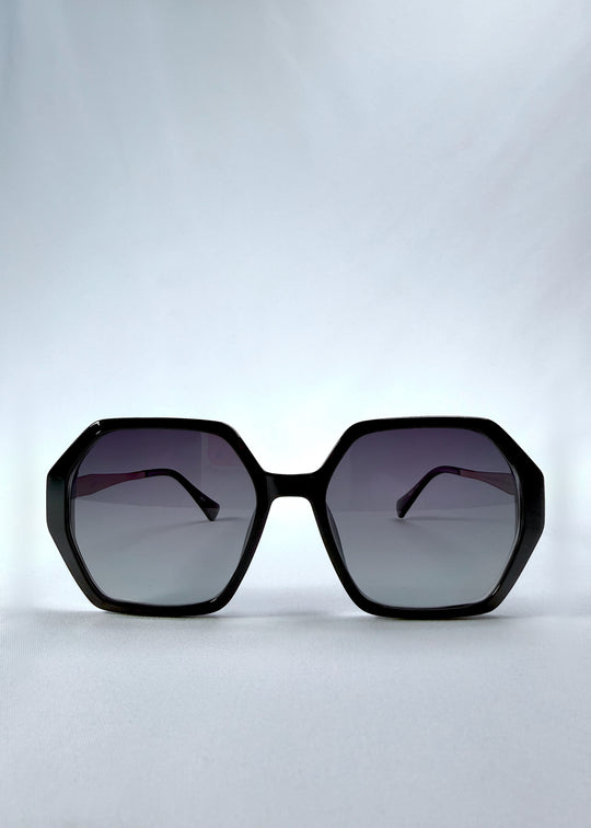 Front view of Ciel Arc sunglasses in Duskgold, featuring black and gold frame with dark lenses, showing the full front silhouette.