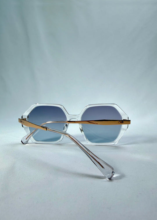 Folded back view of Ciel Arc sunglasses in Glacial Blue, featuring clear frame with blue gradient lenses, showing the folded temples and back structure.