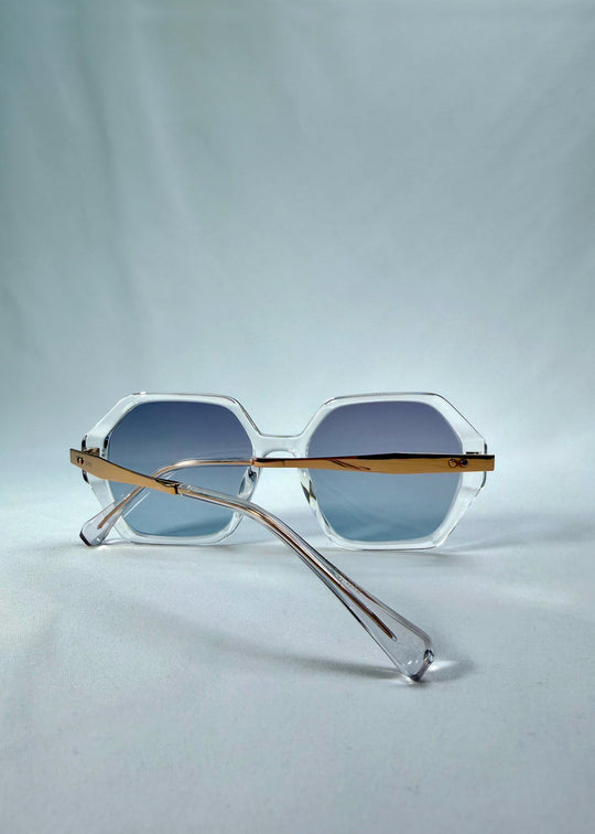 Folded back view of Ciel Arc sunglasses in Glacial Blue, featuring clear frame with blue gradient lenses, showing the folded temples and back structure. 