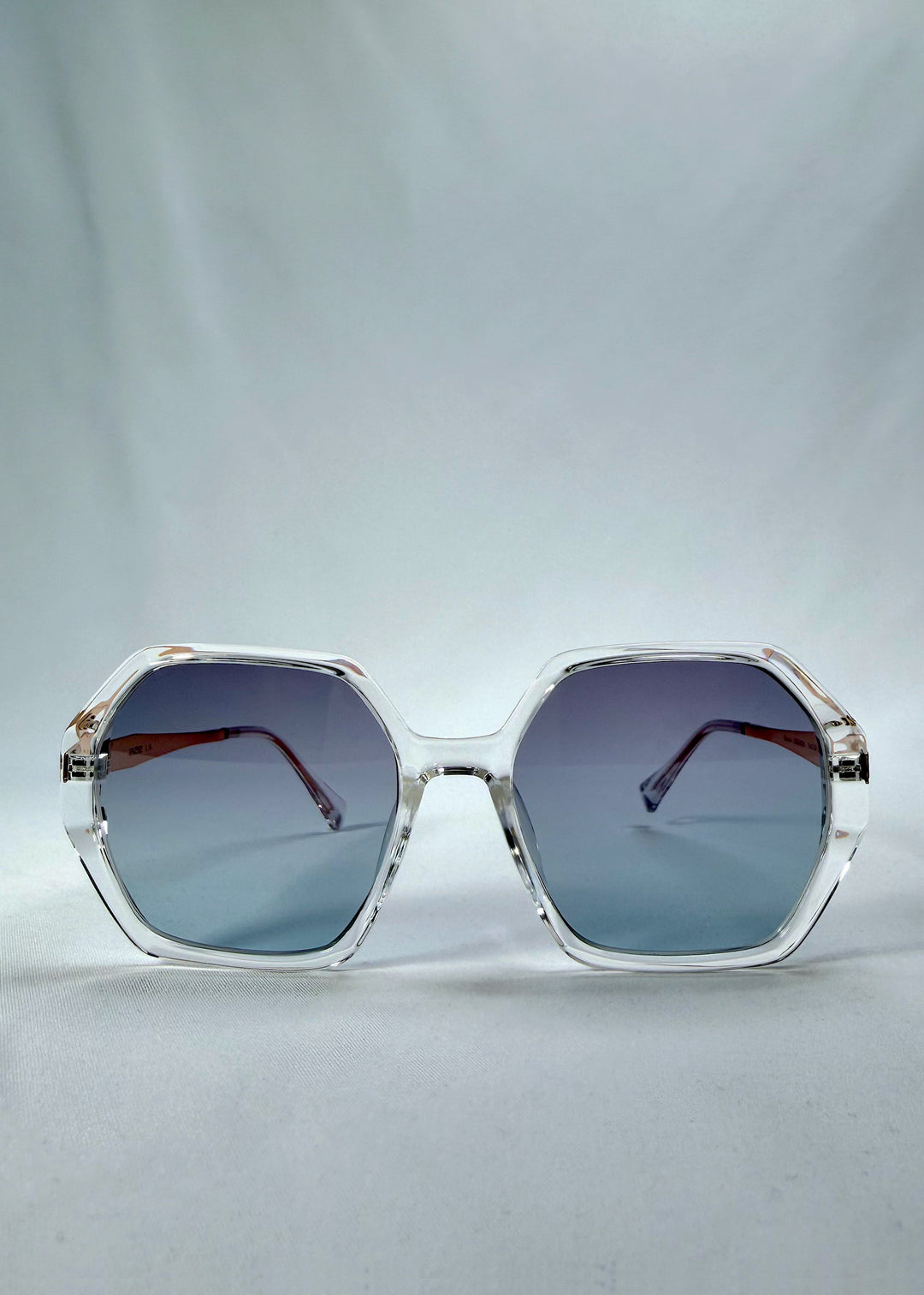 Front view of Ciel Arc sunglasses in Glacial Blue, featuring clear frame with blue gradient lenses, showing the full front silhouette.