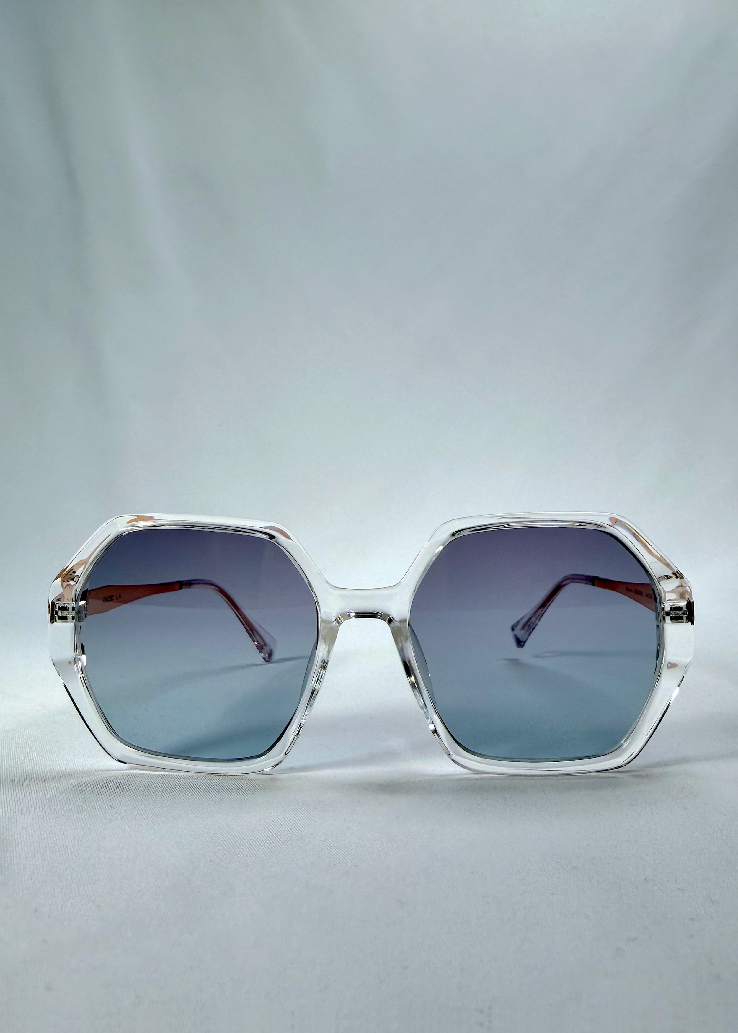 Front view of Ciel Arc sunglasses in Glacial Blue, featuring clear frame with blue gradient lenses, showing the full front silhouette.