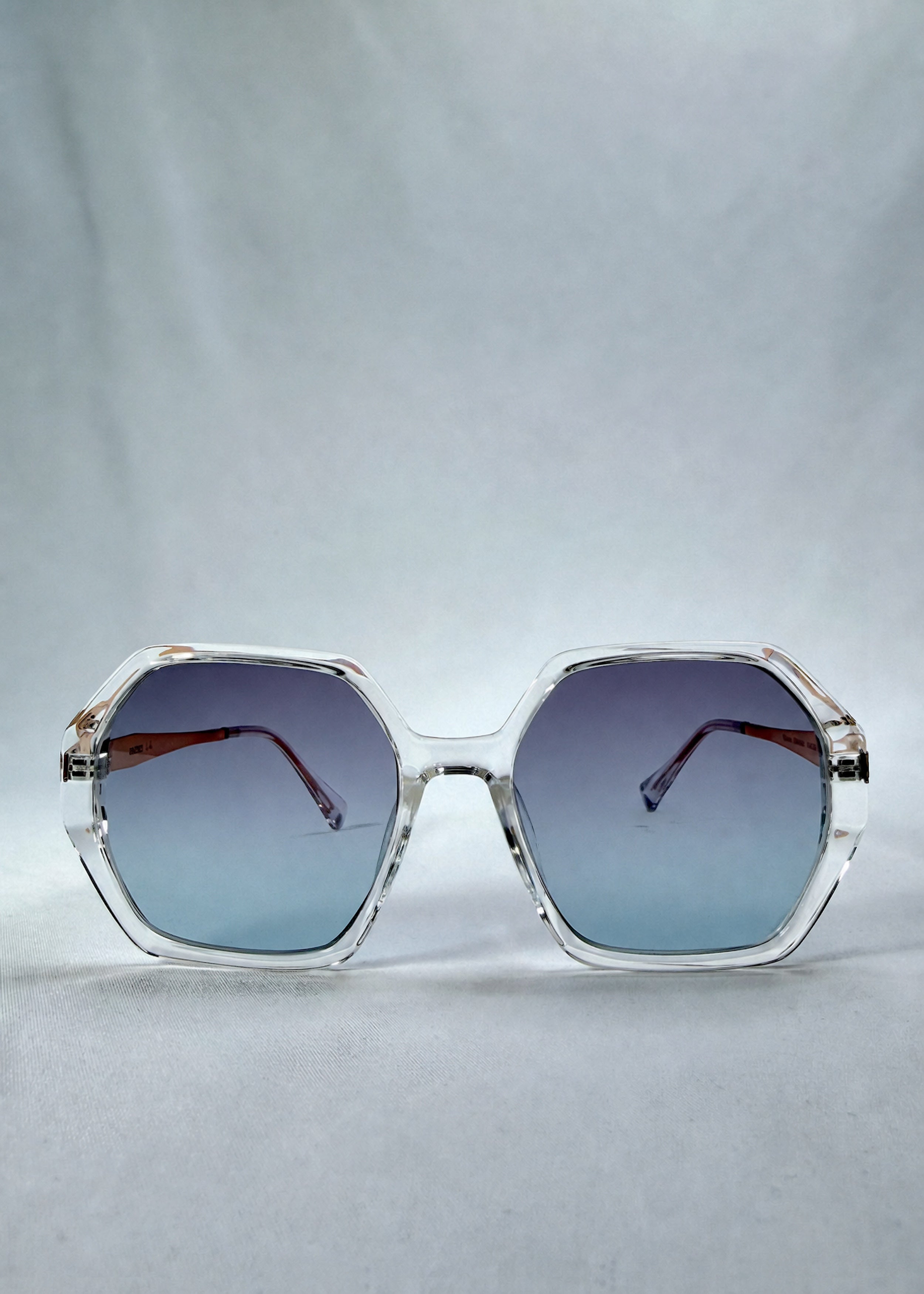 Front view of Ciel Arc sunglasses in Glacial Blue, featuring clear frame with blue gradient lenses, showing the full front silhouette.