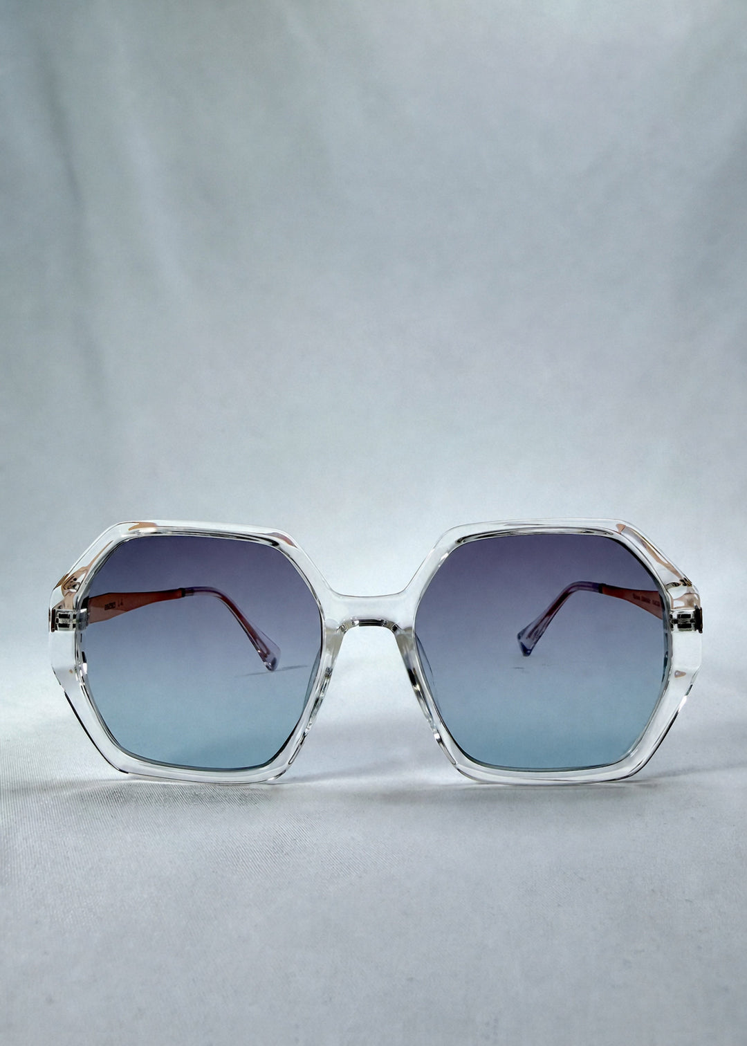 Front view of Ciel Arc sunglasses in Glacial Blue, featuring clear frame with blue gradient lenses, showing the full front silhouette. 