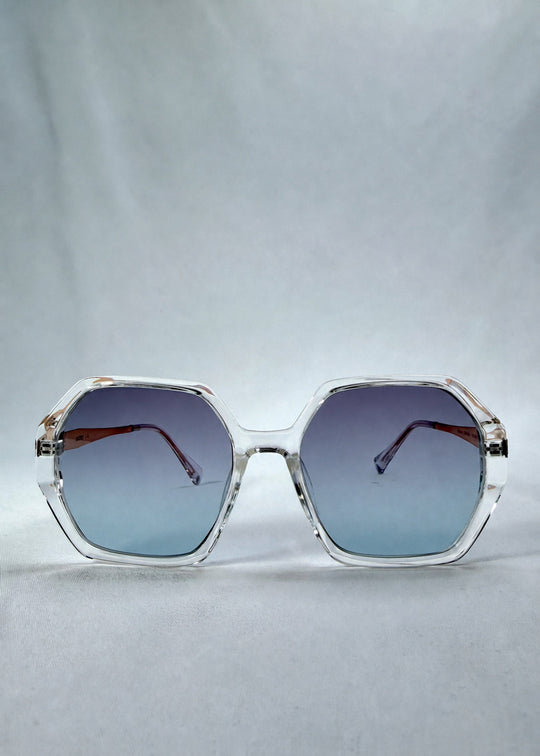 Front view of Ciel Arc sunglasses in Glacial Blue, featuring clear frame with blue gradient lenses, showing the full front silhouette. 