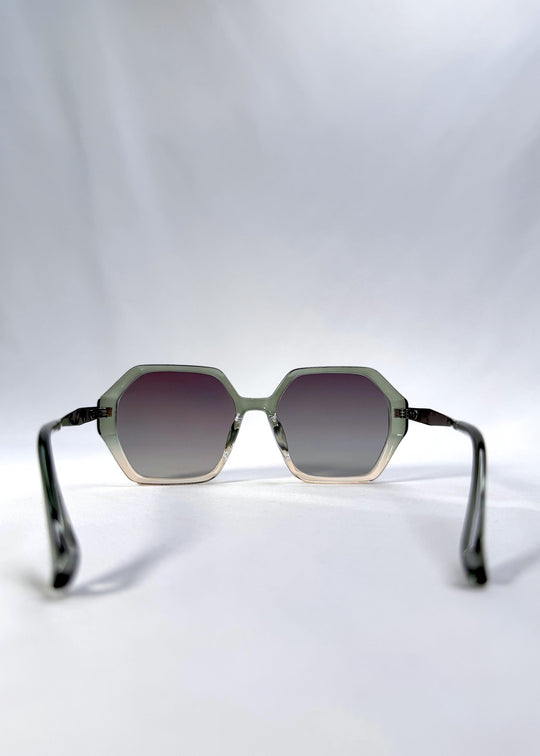 Back view of Ciel Arc sunglasses in Jade Phase, featuring green-toned frame and smoky green lenses, showing the inside frame and open temples. 