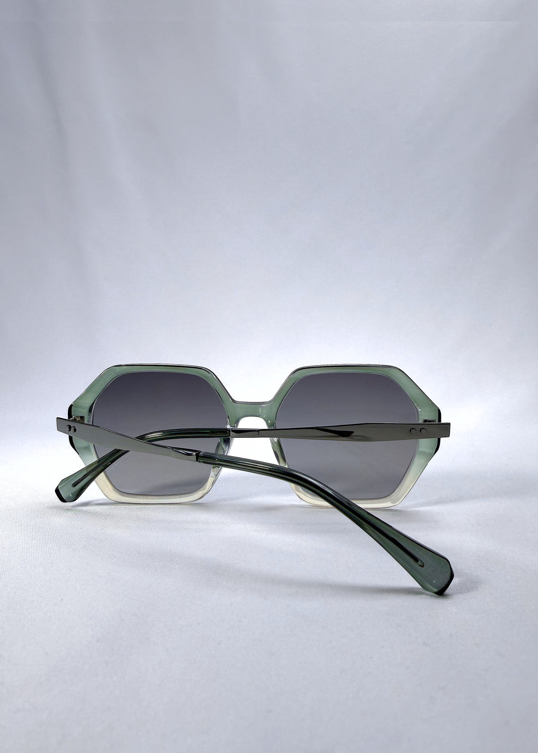 Folded back view of Ciel Arc sunglasses in Jade Phase, featuring green-toned frame and smoky green lenses, showing the folded temples and back structure.