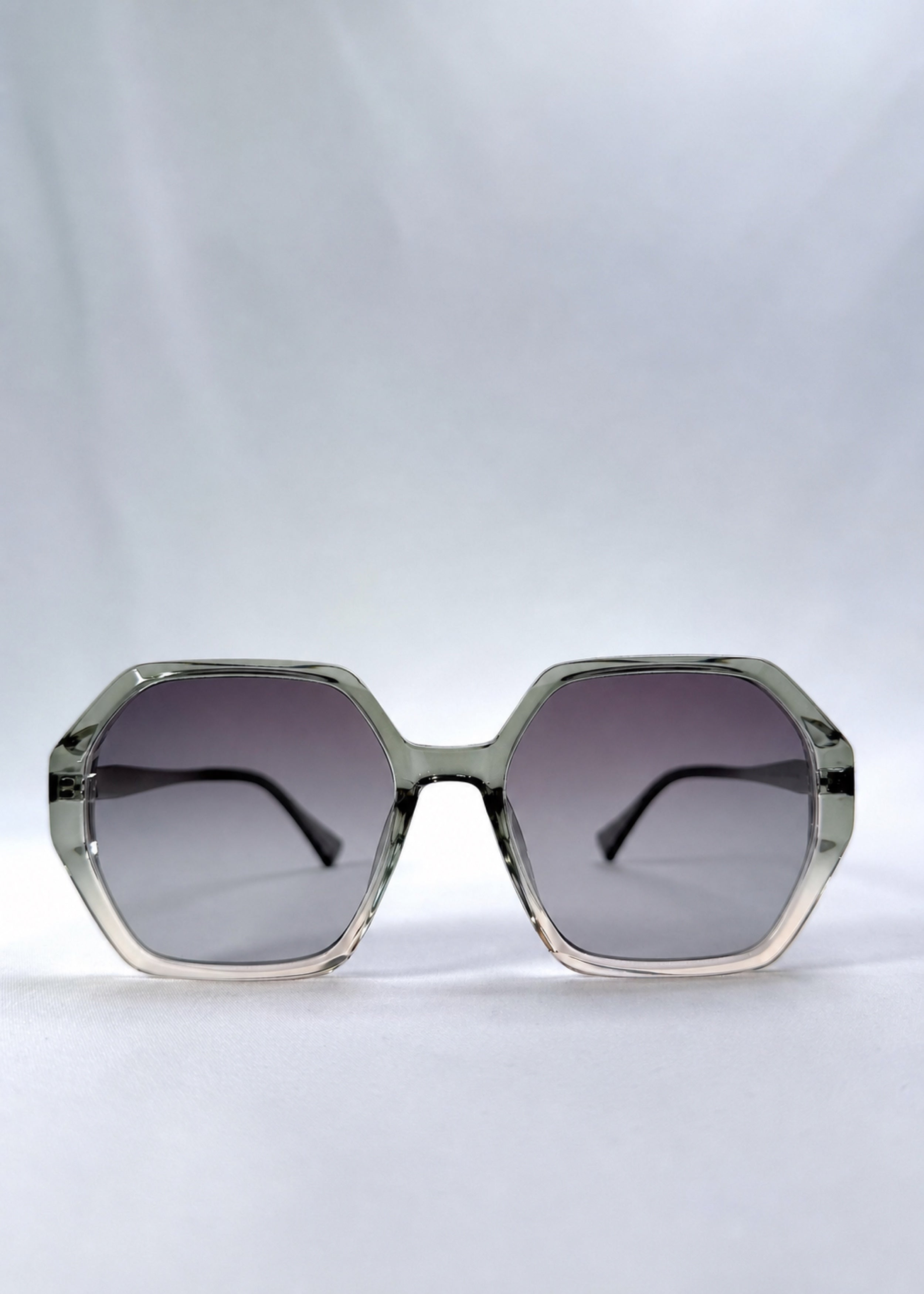 Front view of Ciel Arc sunglasses in Jade Phase, featuring green-toned frame and smoky green lenses, showing the full front silhouette.