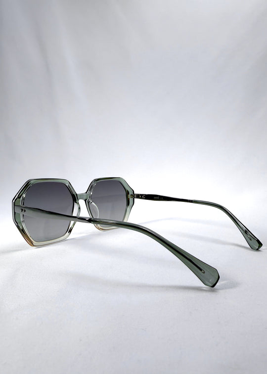 Side-angle view of Ciel Arc sunglasses in Jade Phase, featuring green-toned frame and smoky green lenses, showing the lens shape and side temple profile.