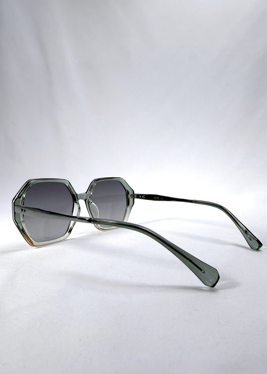 Side-angle view of Ciel Arc sunglasses in Jade Phase, featuring green-toned frame and smoky green lenses, showing the lens shape and side temple profile. 