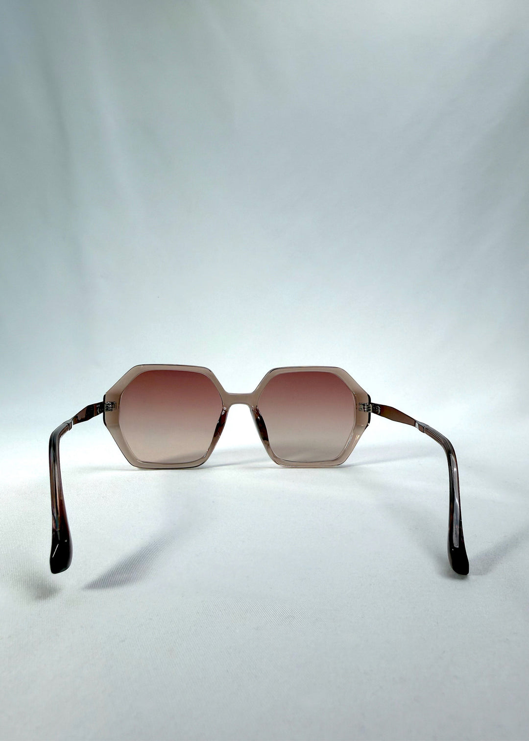 Back view of Ciel Arc sunglasses in Mocha Bronze, featuring mocha bronze frame and warm brown gradient lenses, showing the inside frame and open temples. 