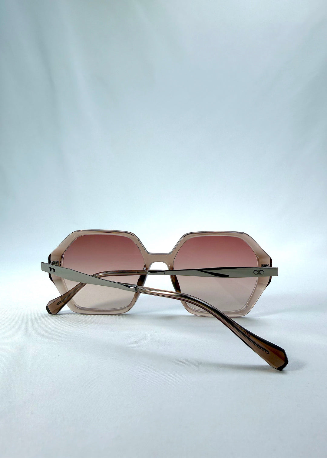 Folded back view of Ciel Arc sunglasses in Mocha Bronze, featuring mocha bronze frame and warm brown gradient lenses, showing the folded temples and back structure.