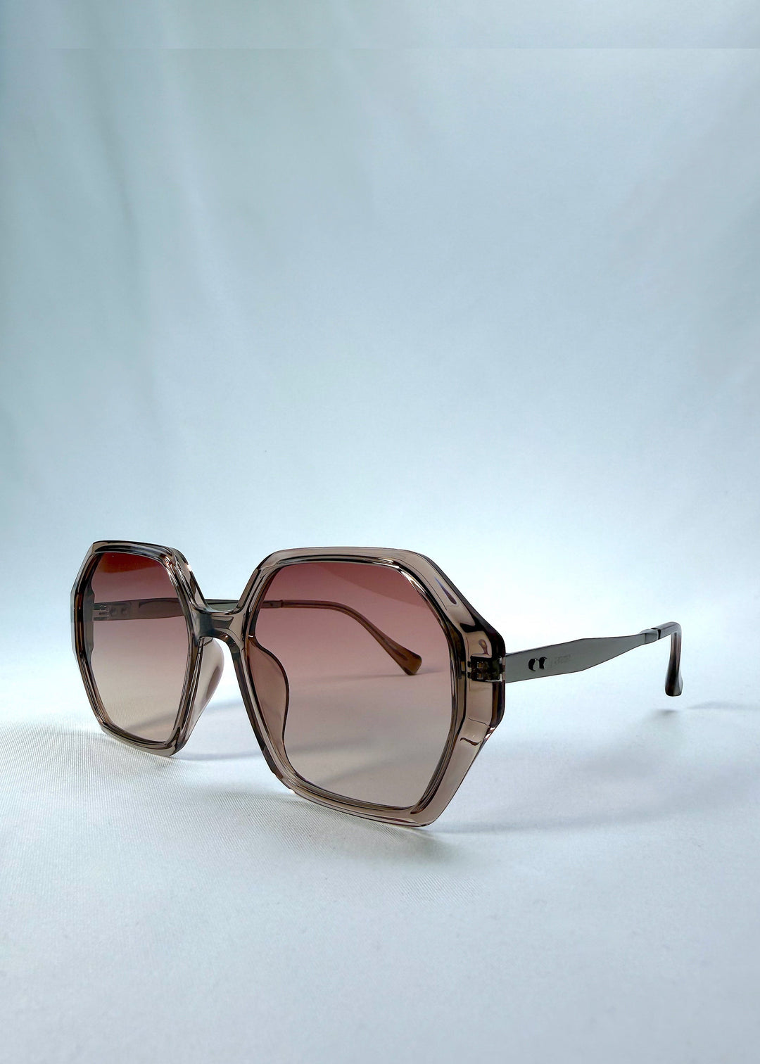 Three-quarter front view of Ciel Arc sunglasses in Mocha Bronze, featuring mocha bronze frame and warm brown gradient lenses, showing the front shape and temple profile. 