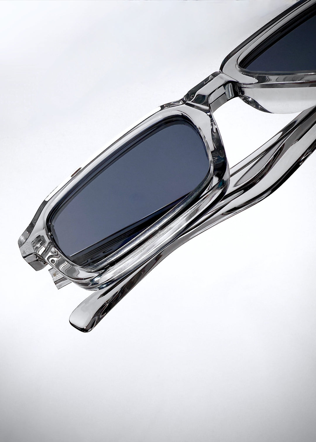 Folded top-down view of Crest - Glacier sunglasses showcasing the translucent acetate frame and dark blue polarized lenses. 