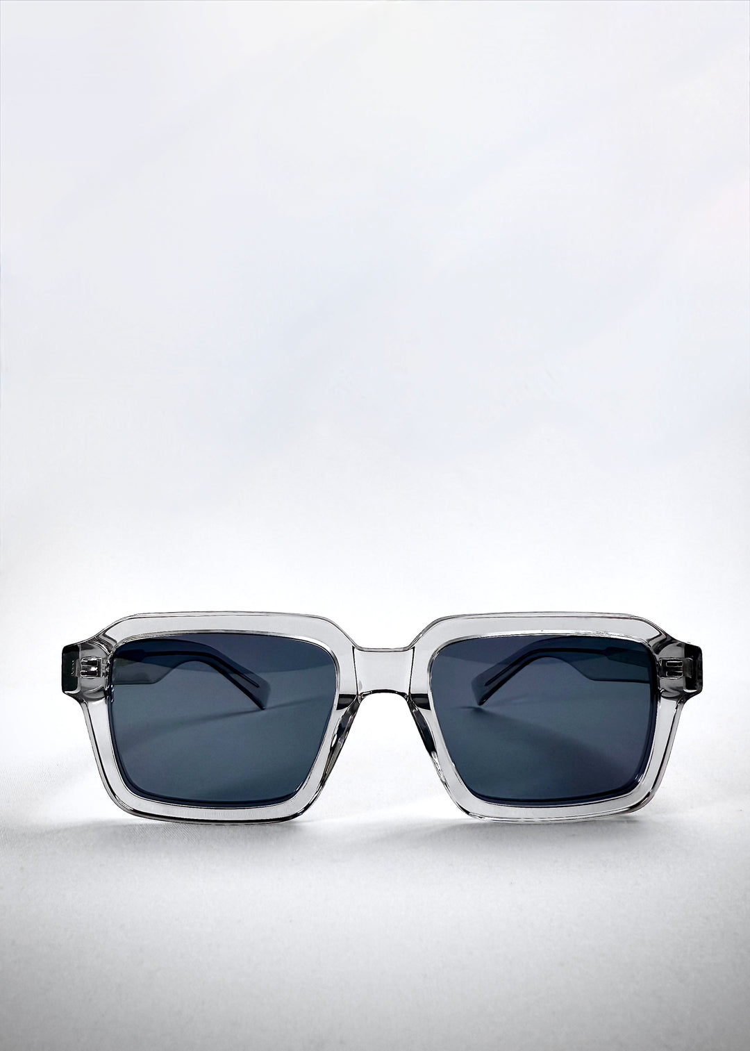 Front view of Crest - Glacier sunglasses showcasing the squared translucent frame and icy blue polarized lenses.