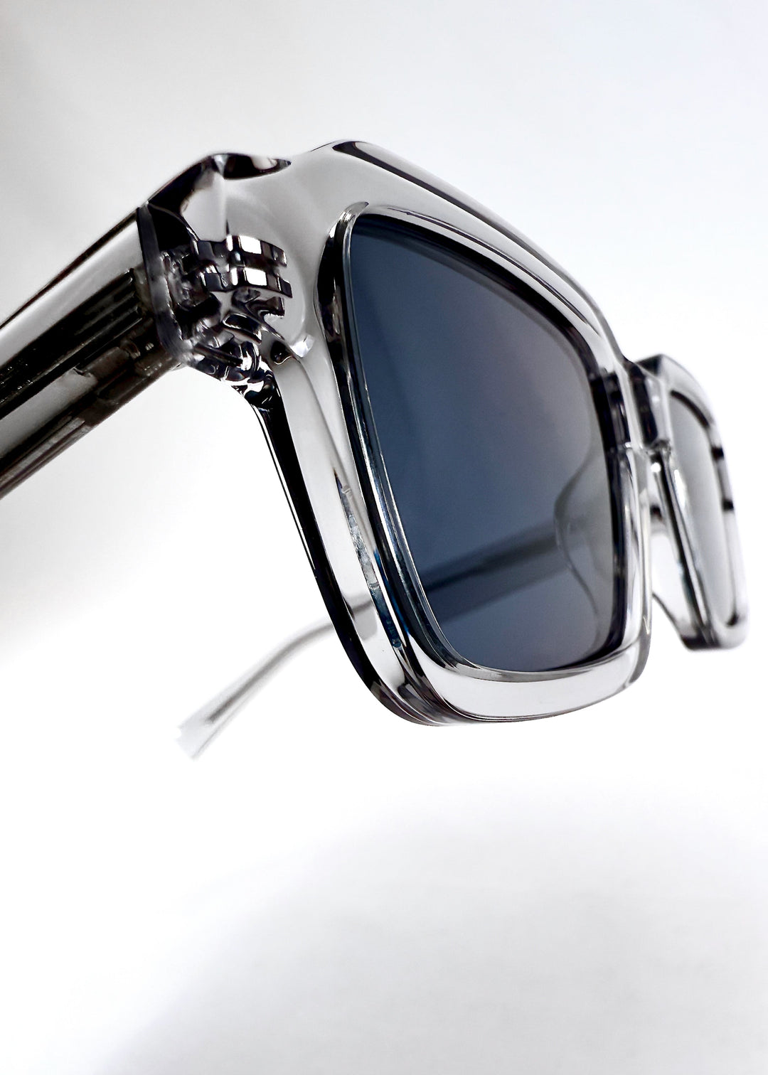 Close-up of the temple and hinge area, emphasizing the clear acetate construction and precise assembly.